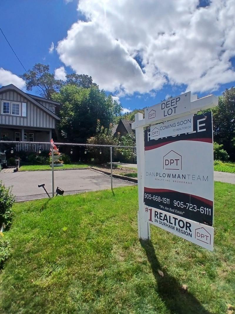 A for sale lawn sign on a white post and arm frame on an Ajax front lawn, carrying a deep lot rider above the header and a coming soon strip across the for sale header.